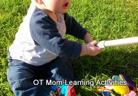Baby crossing the midline with both hands to grasp a toy Baby crossing the midline with both hands to grasp a toy