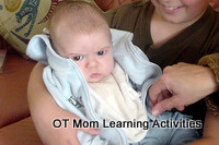 baby showing signs of becoming over-stimulated by environment