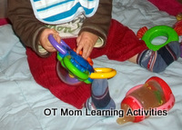 Baby exploring toys with both hands Baby exploring toys with both hands