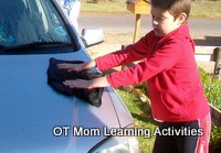 Using both hands on a cloth to clean a car is a good bilateral activity for kids