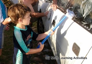 washing windows with a squeegee is a good bilateral coordination activity for kids