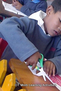child has elevated shoulder during scissor cutting task