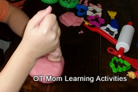Pounding playdough is a great preschool playdough exercise to work on motor skills