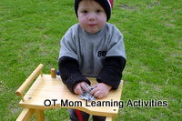 Using both hands on a cloth to clean a surface is a good bilateral activity for kids