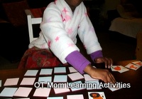 child reaching across the midline to pick up a card child reaching across the midline to pick up a card
