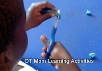 snipping playdough to develop scissor skills