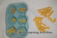 sorting pasta shapes into an egg box