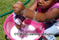 toddler squeezing cloth to develop hand strength