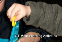 toddler posting discs into a slot