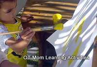 toddler painting with a fat brush