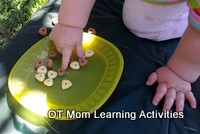 toddler using a pincer grip to pick up cereal