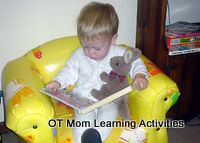toddler reading a board book - turning pages is a fine motor skill