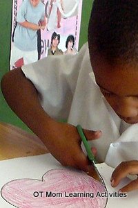 child has elevated shoulder during scissor cutting task