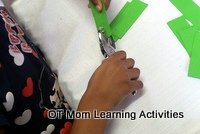 preschool Christmas activity - make paper gift tags - step 3 - punch a hole with a single hole paper punch