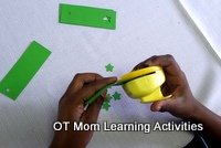 preschool Christmas activity - make paper gift tags - step 5 - use a craft punch to make a decorative hole