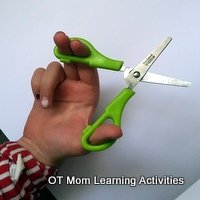 how to hold scissors with two oval holes