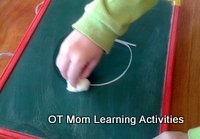 practice letter formations on a small chalkboard